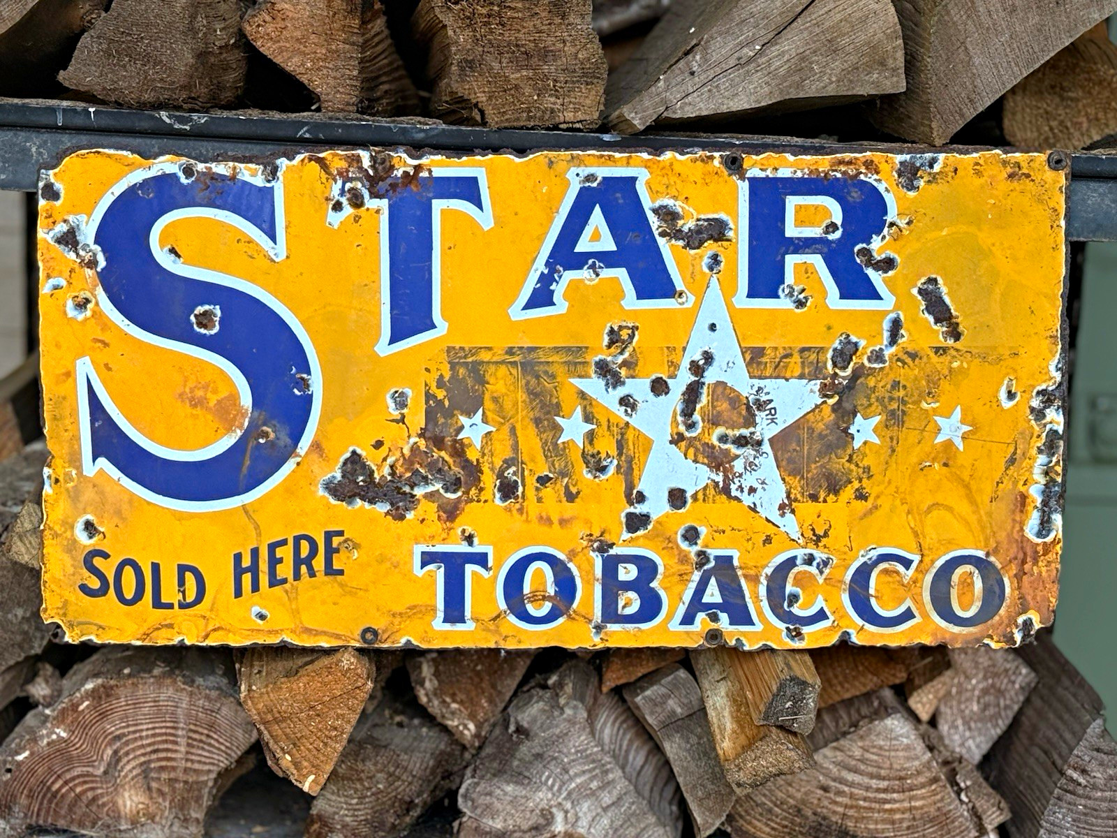 This is an absolutely unique, antique 1920s-1930s Star Tobacco advertising sign
