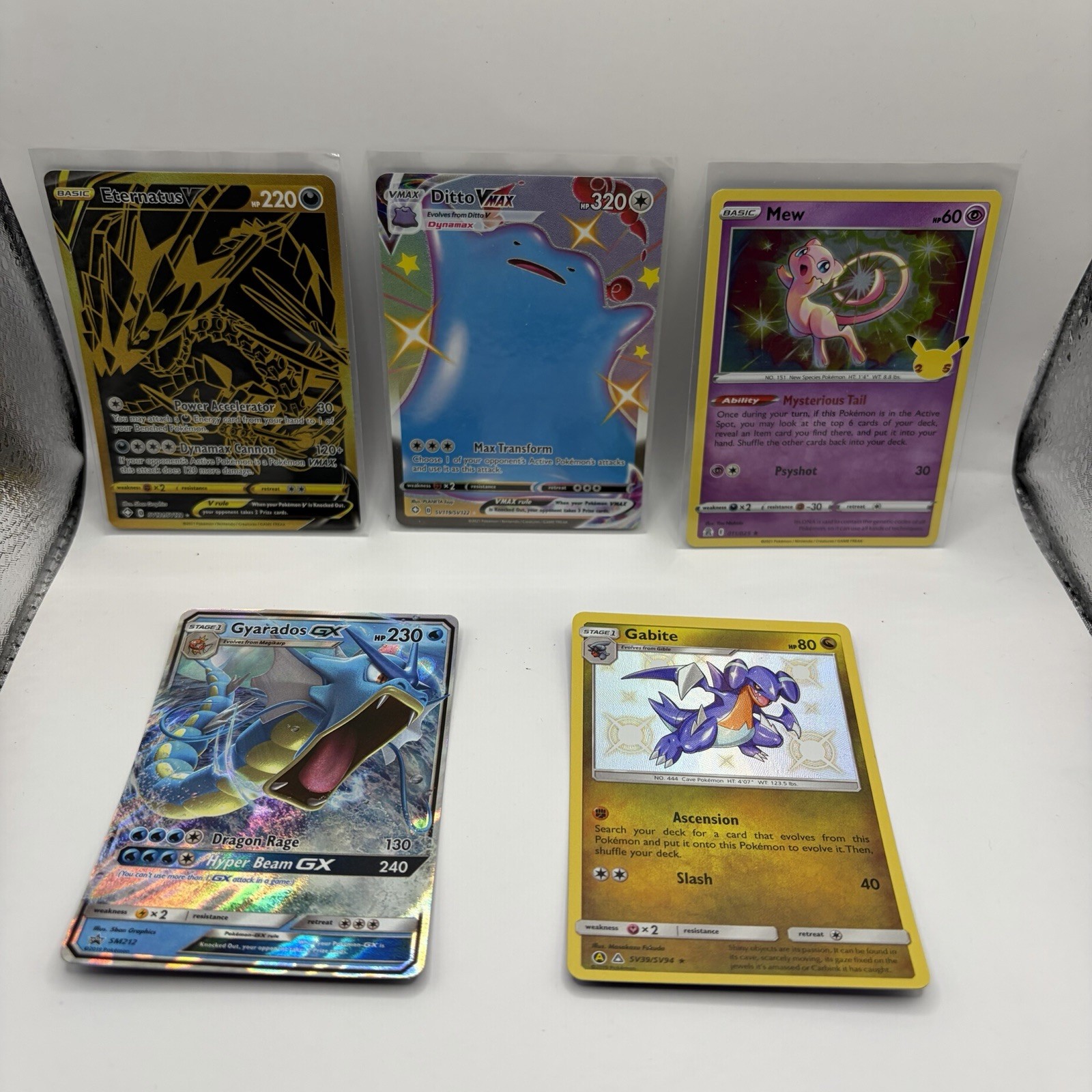 Pokémon card Lot (10)  Eternatus V, Ditto VMAX, Gyarados GX, and Zamazenta V.