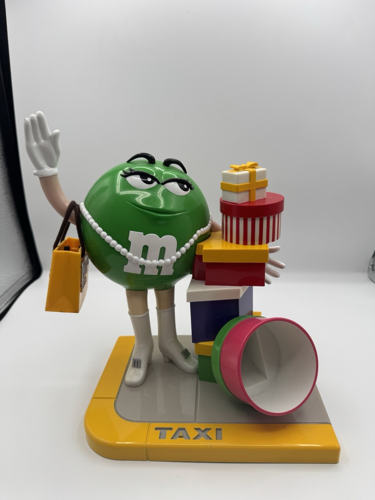 Vintage M&M's Ms. Green Girl M&M Taxi Stand with Gifts Presents Candy Dispenser