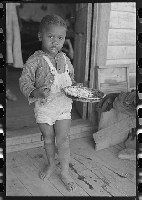 Photo:Southeast Missouri 1938 Child of Sharecropper Eating on Porch