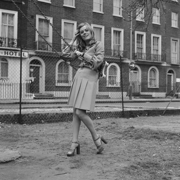 English television actress Wendy Richard poses by a child's swing - Old Photo