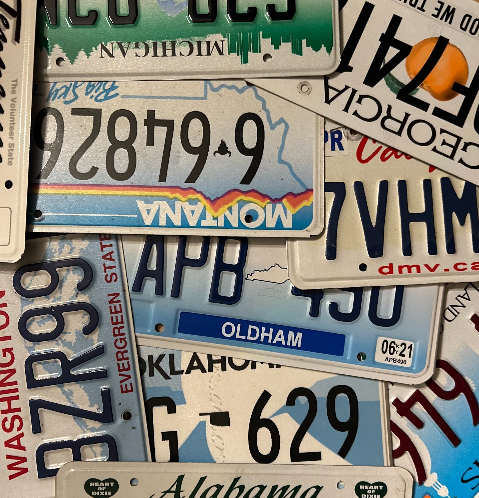 Large lot of 140 colorful license plates from 28 states