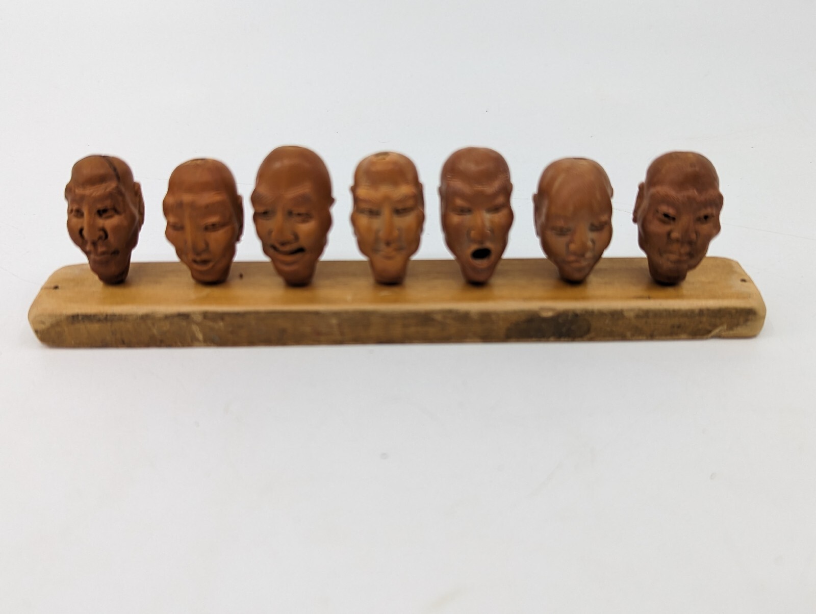 Vintage Set of 7 Chinese Peach Pit Miniature Heads on Wooden Display Stand Rare