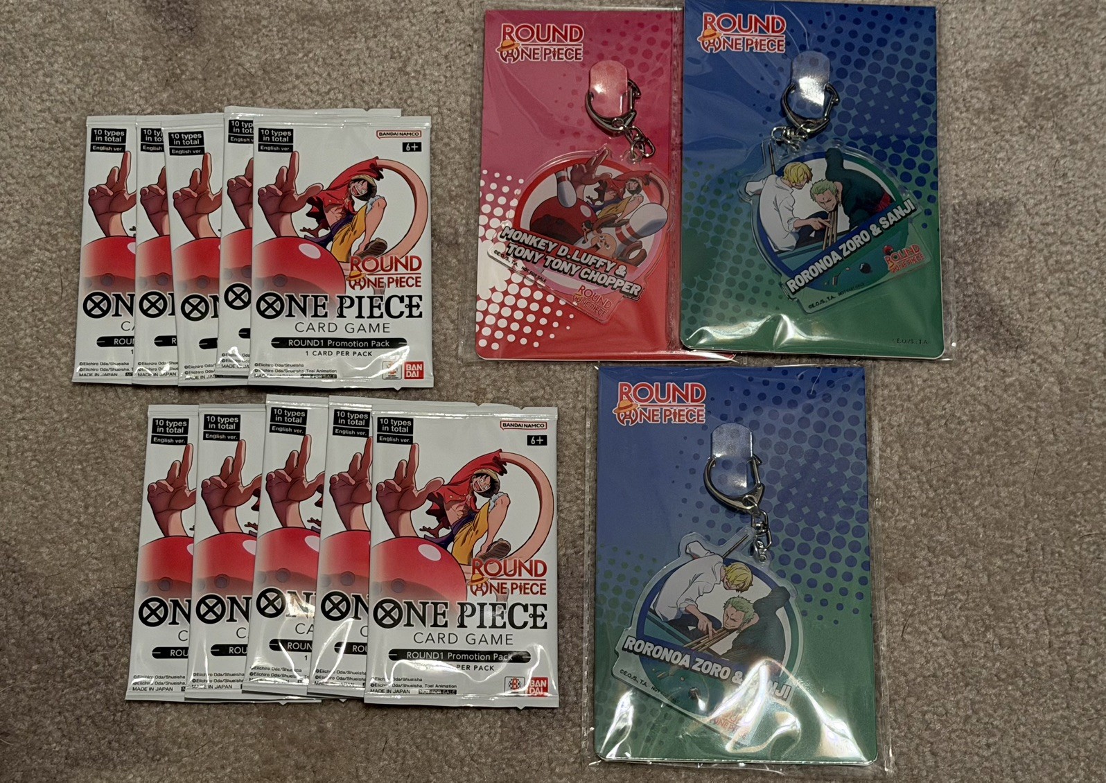 Round 1 x One Piece Trading Card Game Promo Packs - SET OF 10 PACKS + Keychains