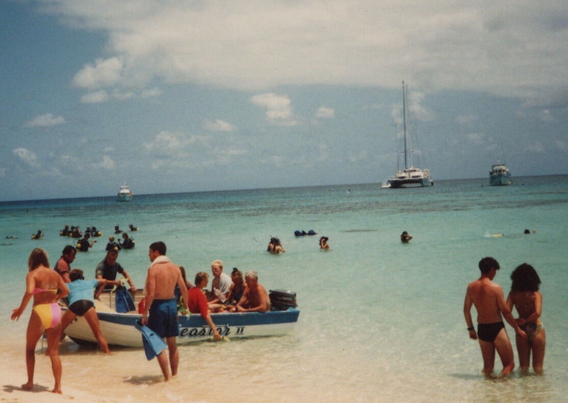 Vibrant Beach Day Colorful Swimsuits Boats in Background 1980s-90s Fun