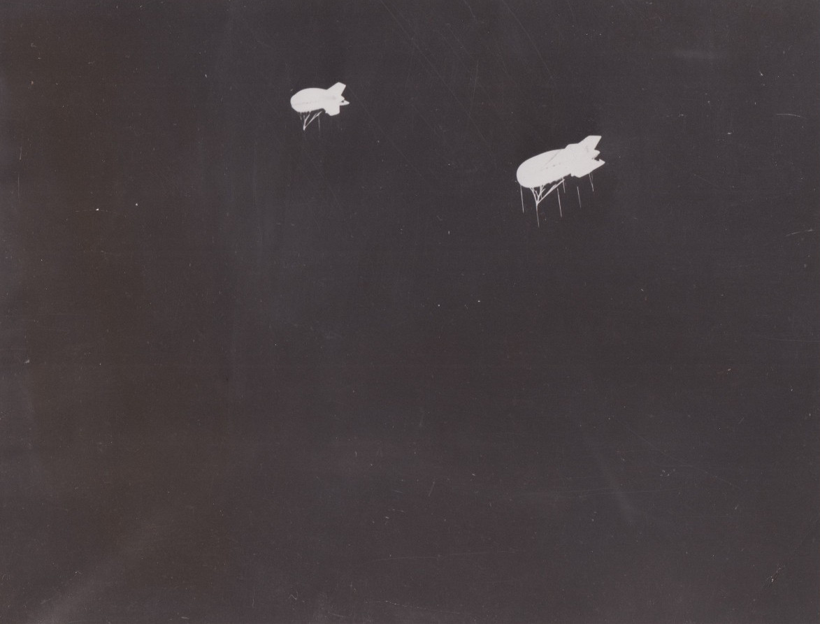 1941 Press Photo Barrage Balloons Lit Up by Night Searchlights, Camp Davis N.C.