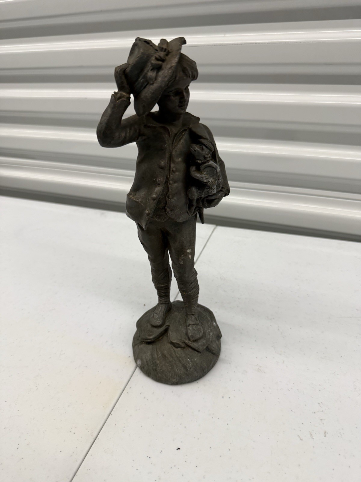 Antique bronze statue of a fisherman boy signed by the French artist Rousseau.