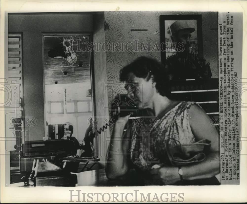 1962 Press Photo Havana hotel guest on phone in hotel lobby after raider attack