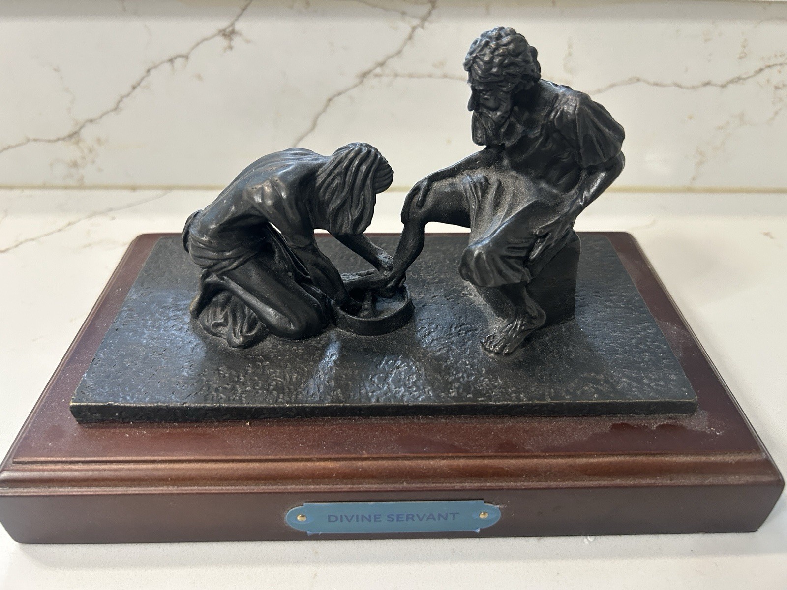 Bronze statue of Jesus washing the feet of Peter, at the last Supper