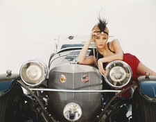 Young woman lying on vintage car portrait Historic 1960s Old Photo picture
