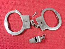 Vintage Pre 1962 American Munitions Handcuffs & H. W. C. Brass Whistle picture