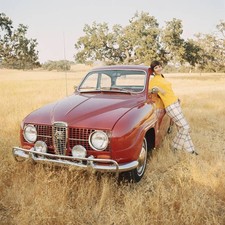 Young woman leaning against vintage car Historic 1960s Old Photo picture