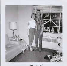 Vtg B&W Snapshot Couple Christmas Window Decorations Rented Furniture 1960 picture