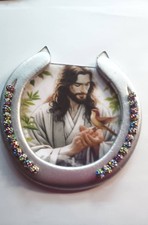 decorated silver horseshoe show casing Jesus in the center picture
