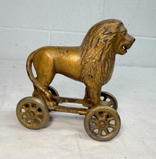 Antique Early 1920s AC Williams Hand Painted Cast Iron Lion Still Bank on wheels picture