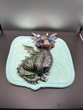 Blue-Eyed grey dinosaur decorated for a fun look picture